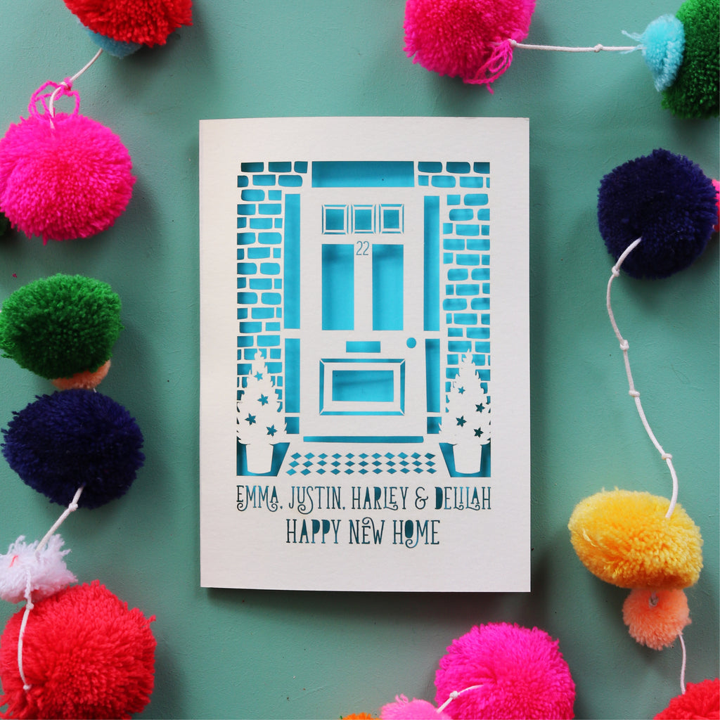 A personalised laser cut card with a front door and names, for home buyers