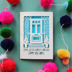 A personalised laser cut card with a front door and names, for home buyers
