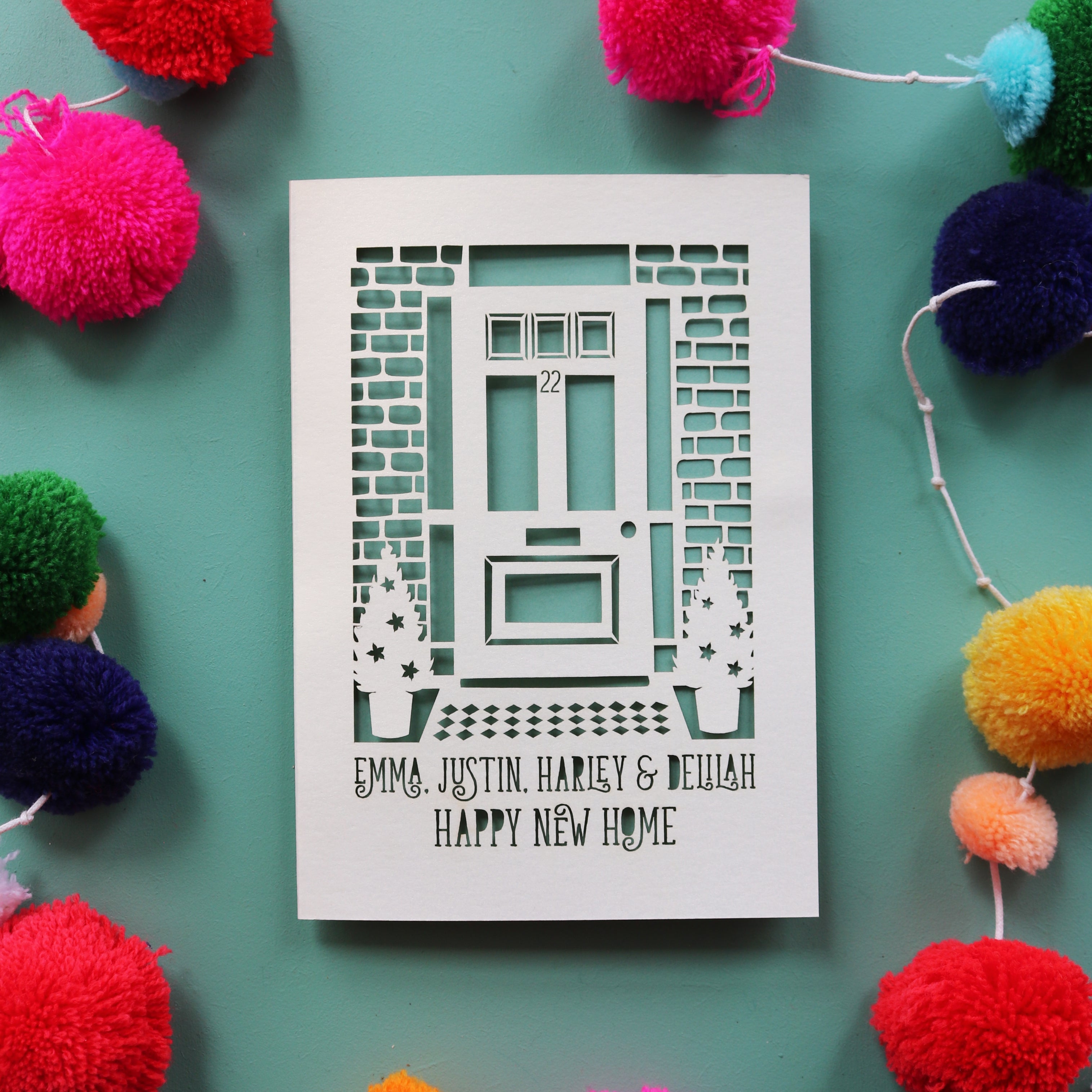 A moving house card with laser cut front door and personalised text