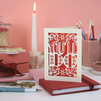 Funny laser cut Valentine's Card with 'You'll Do' design on a desk with stationery items