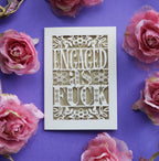 A cut out engagement card that says "Engaged as fuck"