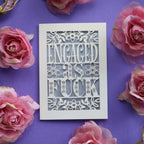 A funny engagement card for friends. Engaged as Fuck is cut out of a cream card with a silver background