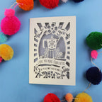 Decorative funny Valentine's card with coffee-themed design and the words "I love you more than coffee, but please don't make me prove it)" on a blue background with colourful pom-poms.