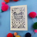 Funny Valentine's Card with floral design and text on a blue background with colourful pom-poms