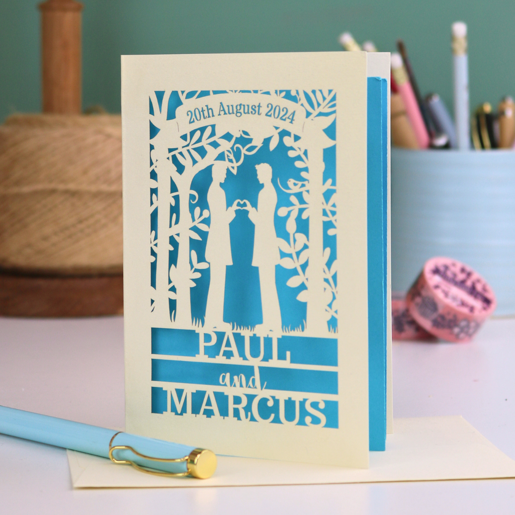 Personalized gey anniversary card with laser-cut design of two men under an arch, with text '20th August 2024', 'PAUL', and 'MARCUS'.