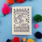 A laser cut girlfriend Valentine's card that features a paper cut out World design and the words "Happy Valentine's Day to the Best Girlfriend in the World"