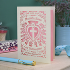 Personalised laser cut Goddaughter Baptism day card with decorative design and text on a wooden surface.