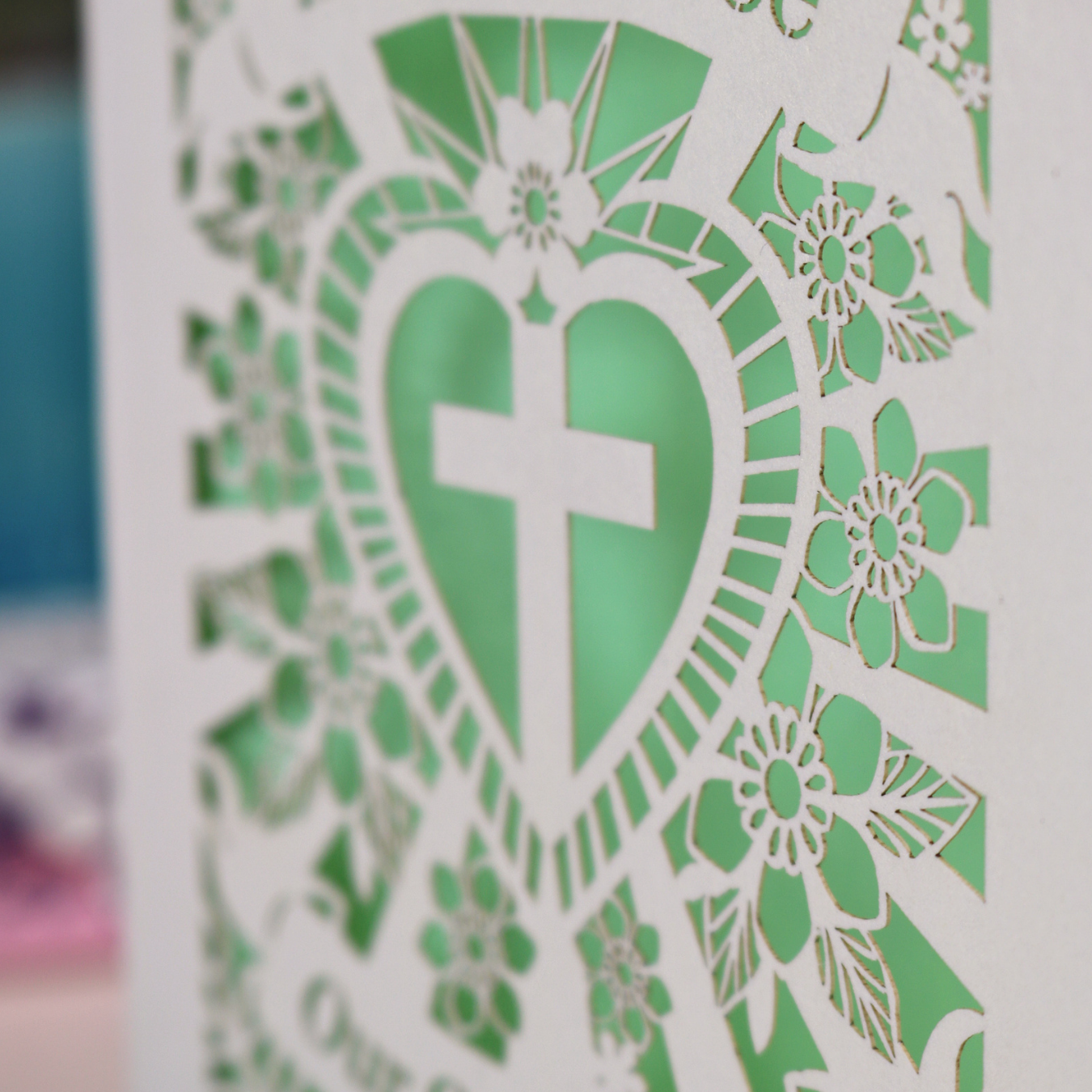 Personalised laser cut Baptism day card with decorative design and text on a wooden surface.