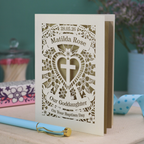 Personalised laser cut Godchild Christening or Baptism day card with decorative design and text on a wooden surface.