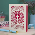Personalised laser cut Baptism day card  for Goddaughter with decorative design and text on a wooden surface.