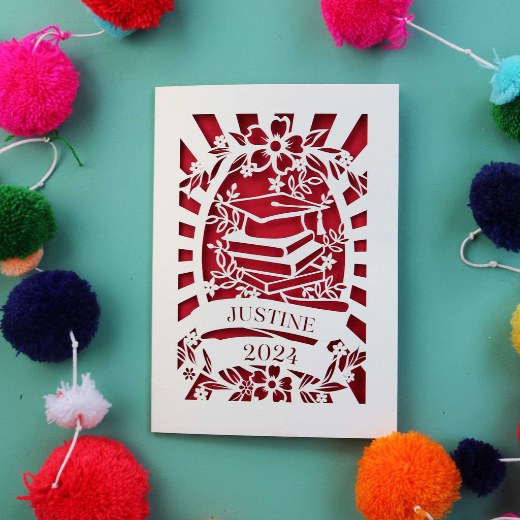 A cream and dark red card for graduation, personalised with a name and year