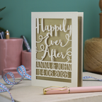 A laser cut wedding card with cut out text, 'Happily Ever After' in a script font, personalised with 'Anna & John, 14.06.2026'