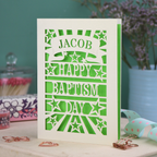 Personalised Baptism Card with 'Happy Baptism Day' text and stars on a decorative background, personalised with a stencil-font cut out name in a banner at the top