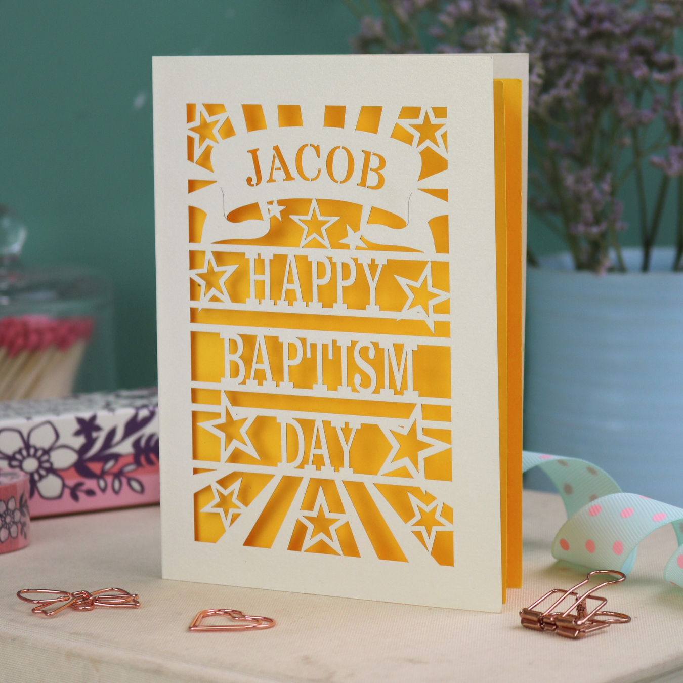 Personalised Baptism Card with 'Happy Baptism Day' text and stars, personalised with a stencil-font cut out name in a banner at the top. 