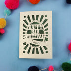 Laser Cut Bar Mitzvah card with 'Happy Bar Mitzvah Noah' text on a blue background with colourful pom-poms.