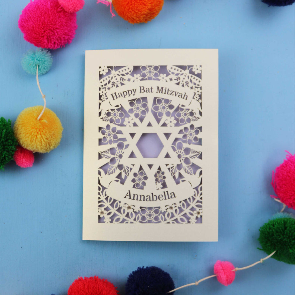 Laser-cut Bat Mitzvah card with decorative elements on a blue background