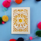 Card for Bat Mitzvah with 'Happy Bat Mitzvah' and 'Annabella' on a blue background with colourful pom-poms.