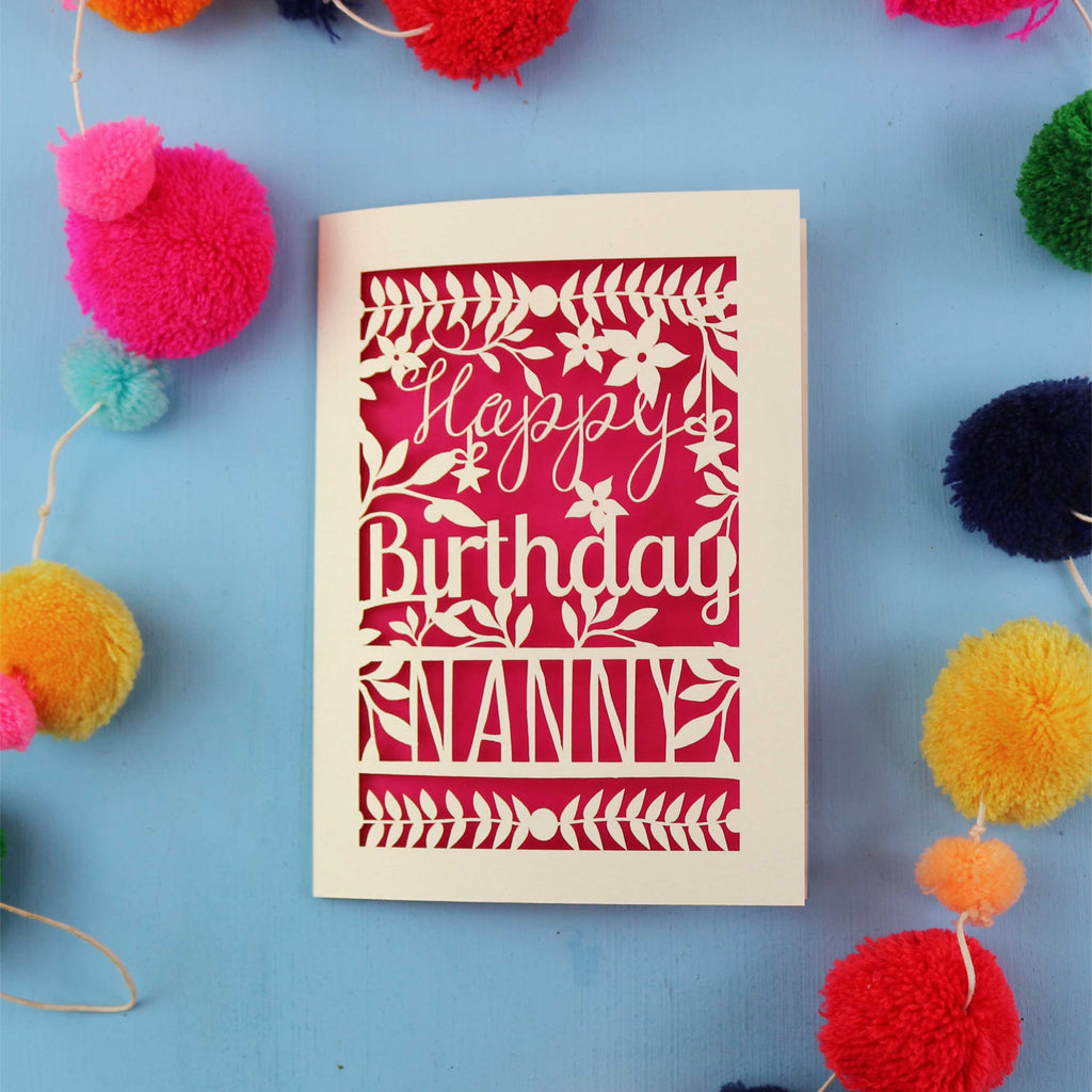 Birthday card for Nanny with colourful pom-poms on a blue background