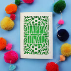 Laser Cut Diwali Card with 'Happy Diwali' design surrounded by colourful pom-poms on a blue background