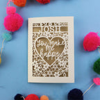 Valentines Card with 'Josh you make me happy' text on a blue background with colourful pom-poms