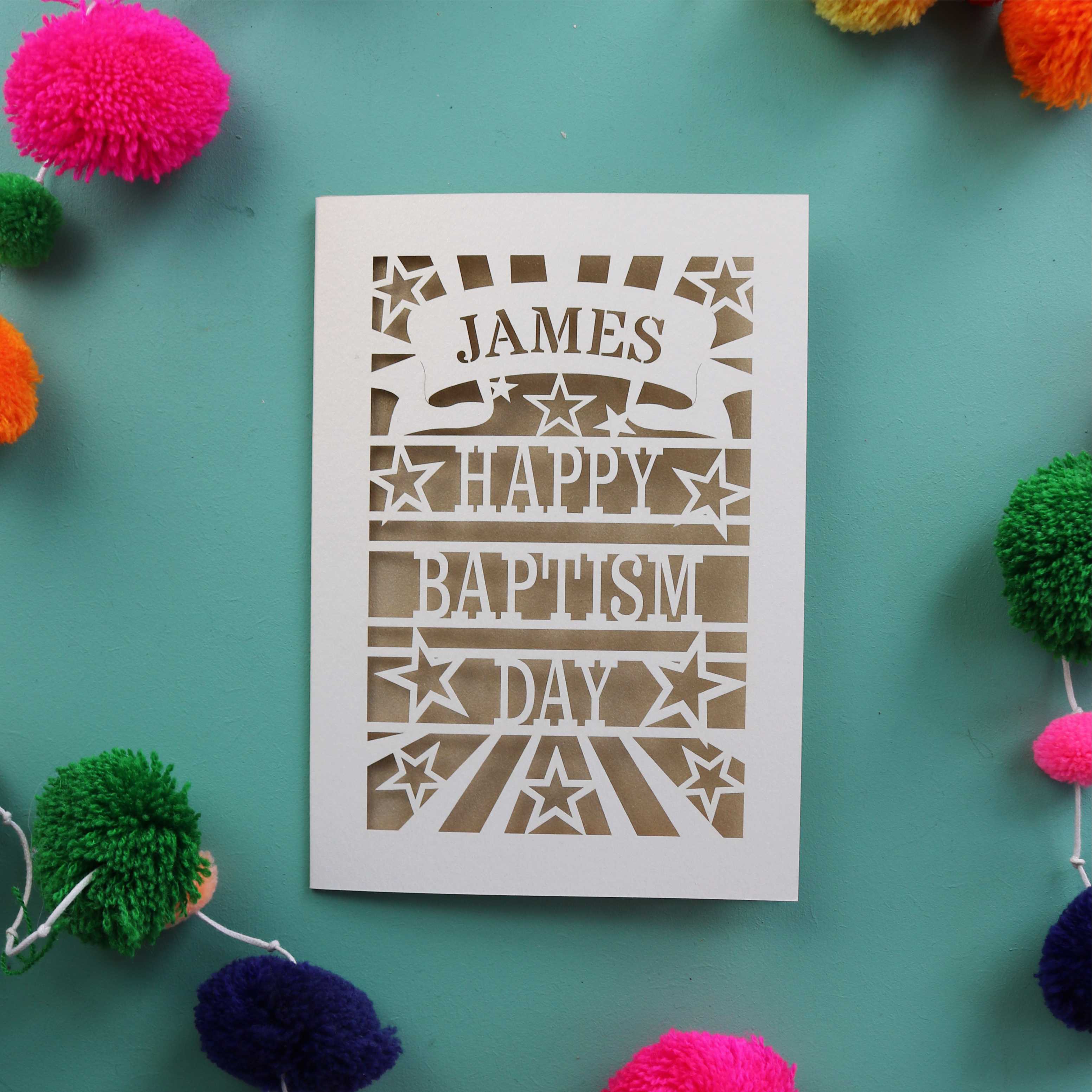 A fun Baptism card that is personalised with a first name in a banner and reads "Happy Baptism Day"
