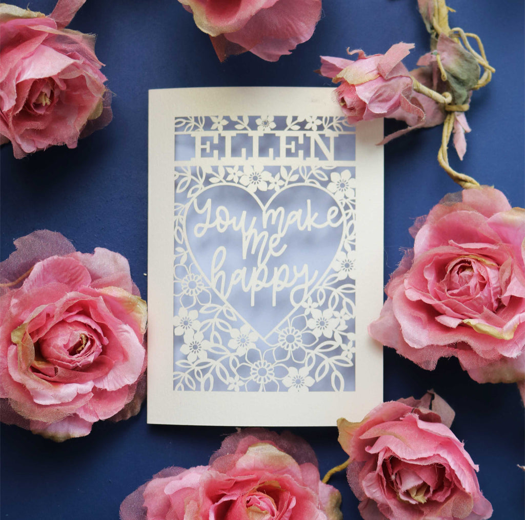 A personalised laser cut Valentines Day Card that says "Name, You make me happy."