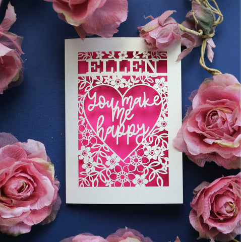 A personalised laser cut Valentine's Card that says "Name, You make me happy."