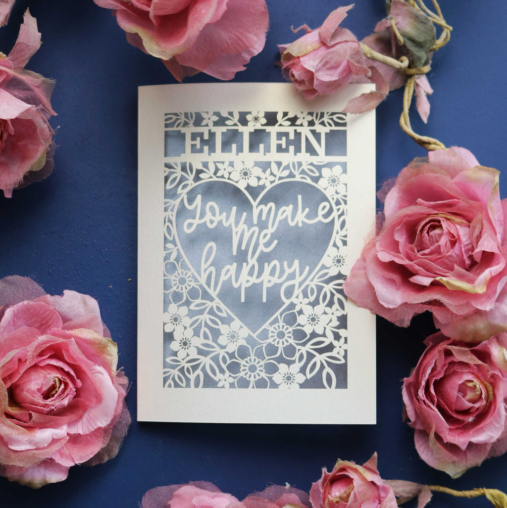 A personalised laser cut Valentine's Card that says "Name, You make me happy."
