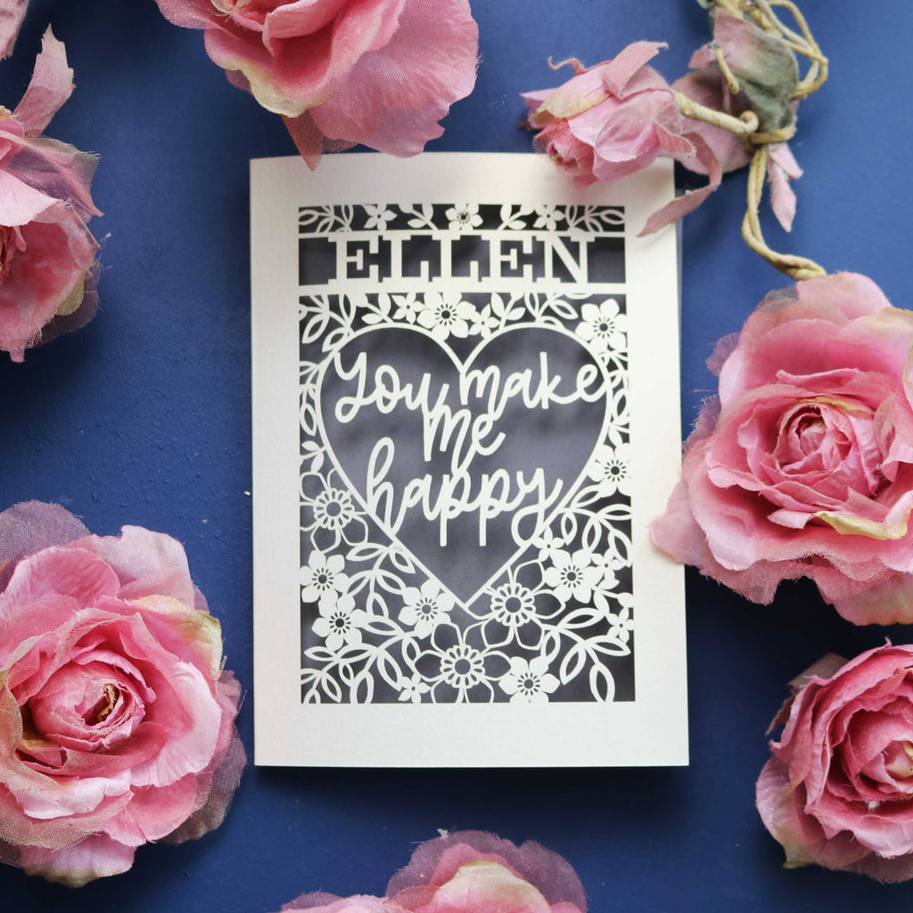 A personalised papercut Valentine's Card that says "Name, You make me happy."