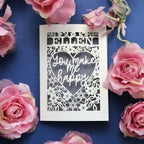 A personalised papercut Valentine's Card that says "Name, You make me happy."