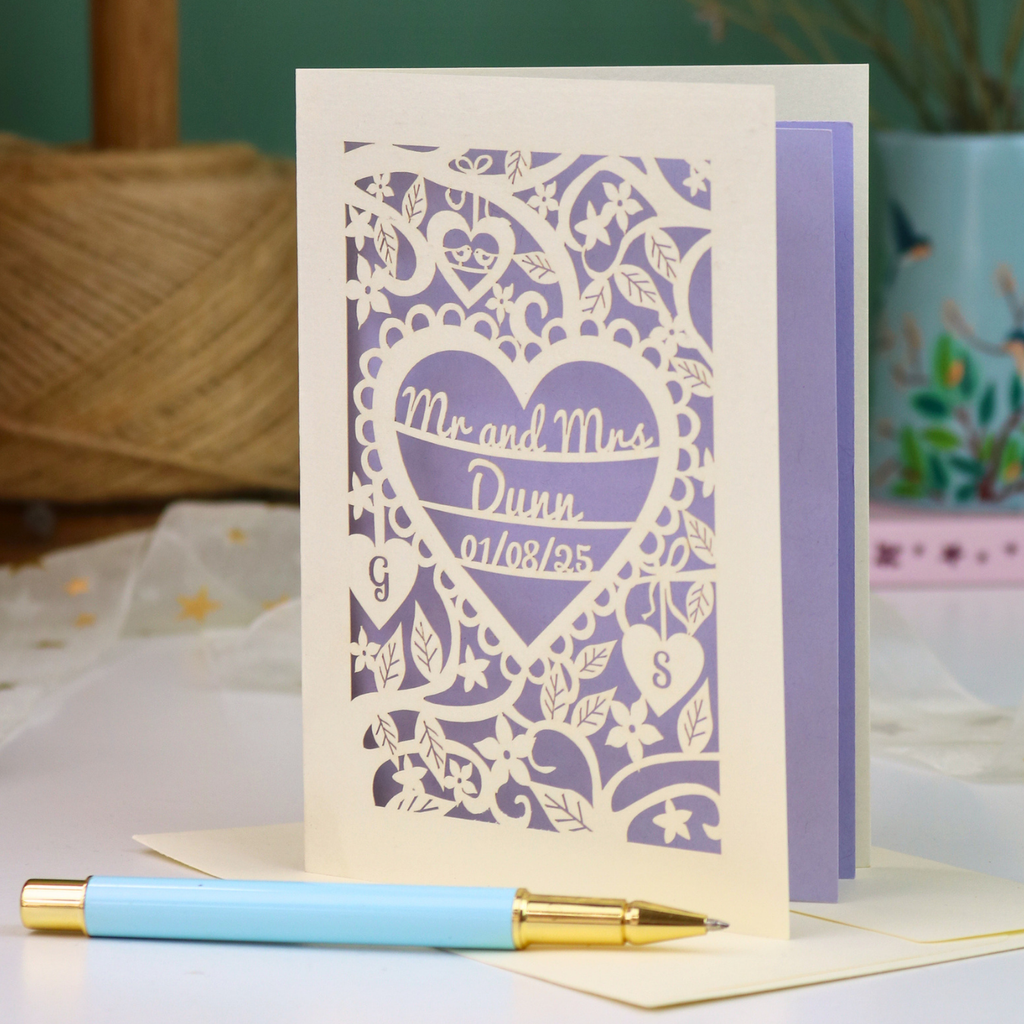 A personalized laser-cut wedding anniversary card with a heart-shaped cut out in the centre reading 'Mr. and Mrs. Dunn, 01/08/25