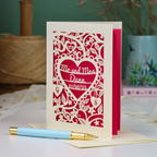 A personalized laser-cut wedding anniversary card with a heart-shaped cut out in the centre reading 'Mr. and Mrs. Dunn, 01/08/25