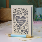 A personalized laser-cut wedding anniversary card with a heart-shaped cut out in the centre reading 'Mr. and Mrs. Dunn, 01/08/25