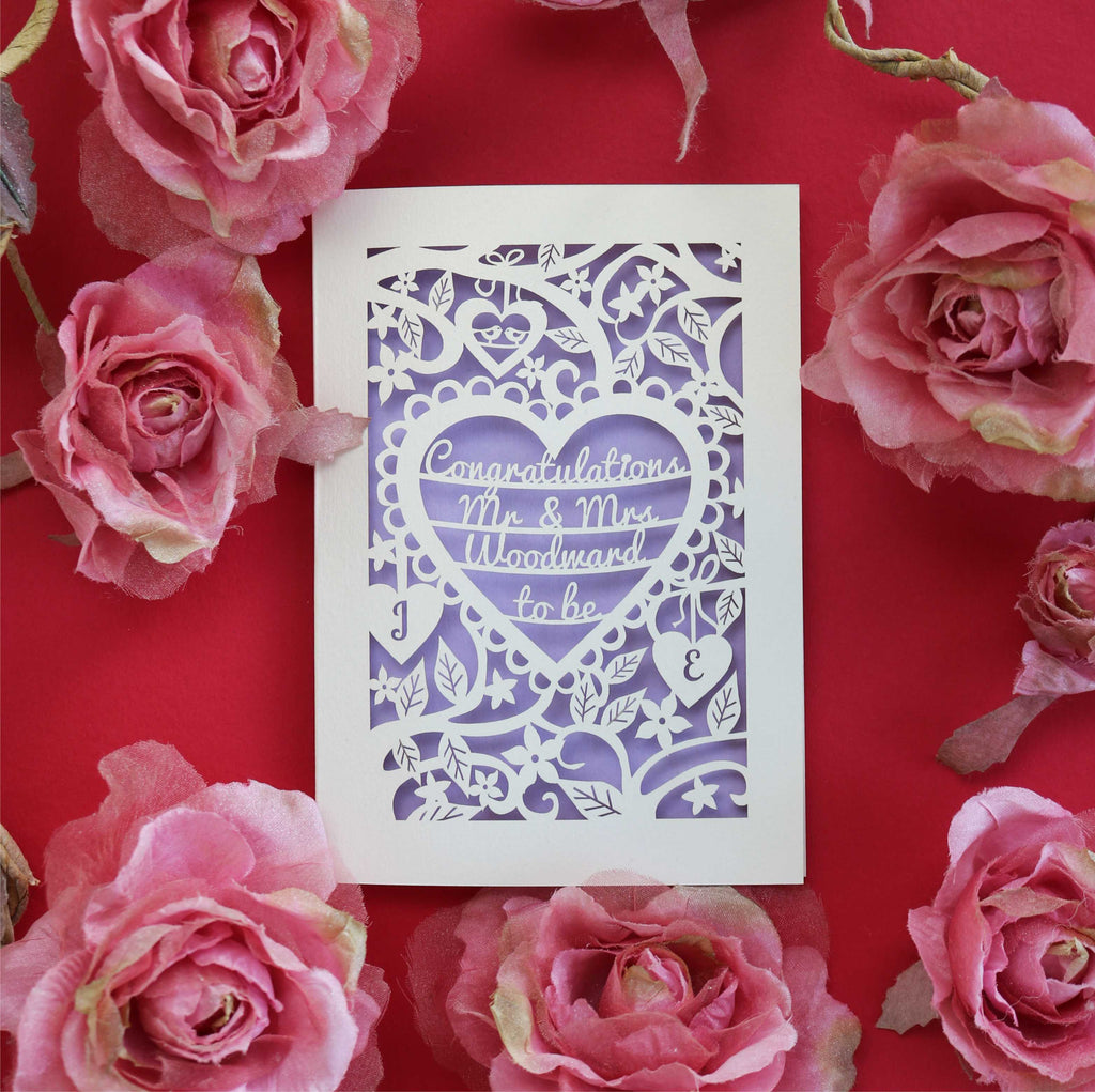 A personalised laser cut card for engagement. Card is personalised with the surname of the couple and says Congratulations Mr and Mrs to be
