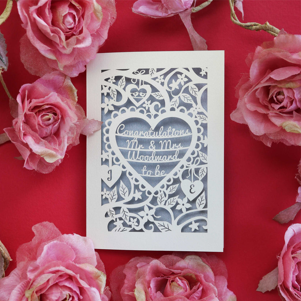 An intricate and floral laser cut engagement card