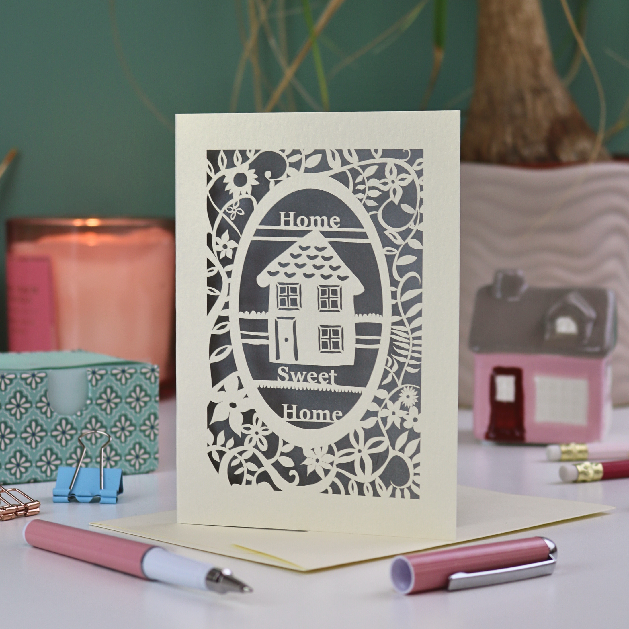 A laser cut new home card with floral border, house design and the words "Home sweet home"