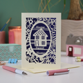 A laser cut new home card with floral border, house design and the words "Home sweet home"