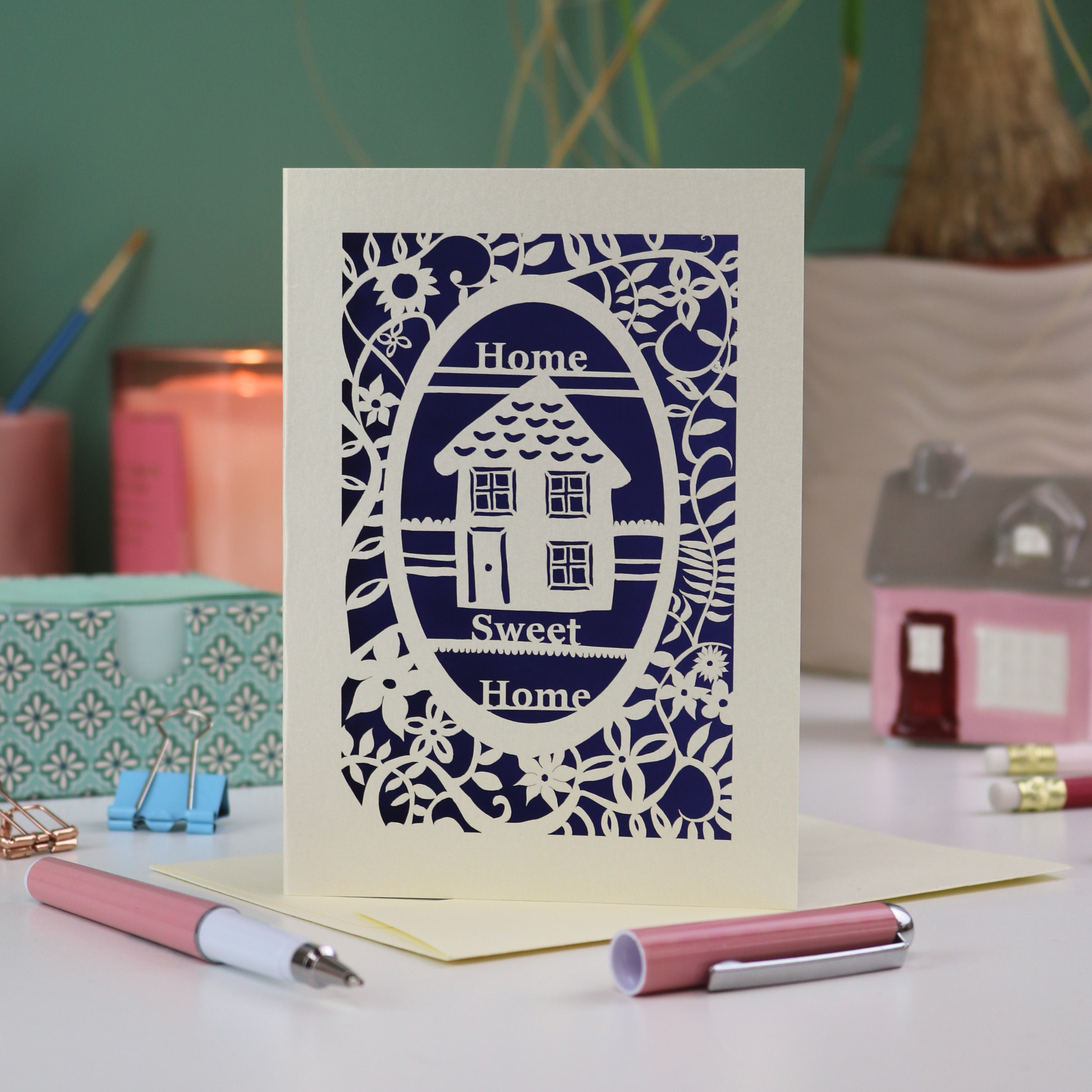 A laser cut new home card with floral border, house design and the words "Home sweet home"