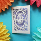 A unique housewarming card that has a laser cut house and the words "Home sweet home"