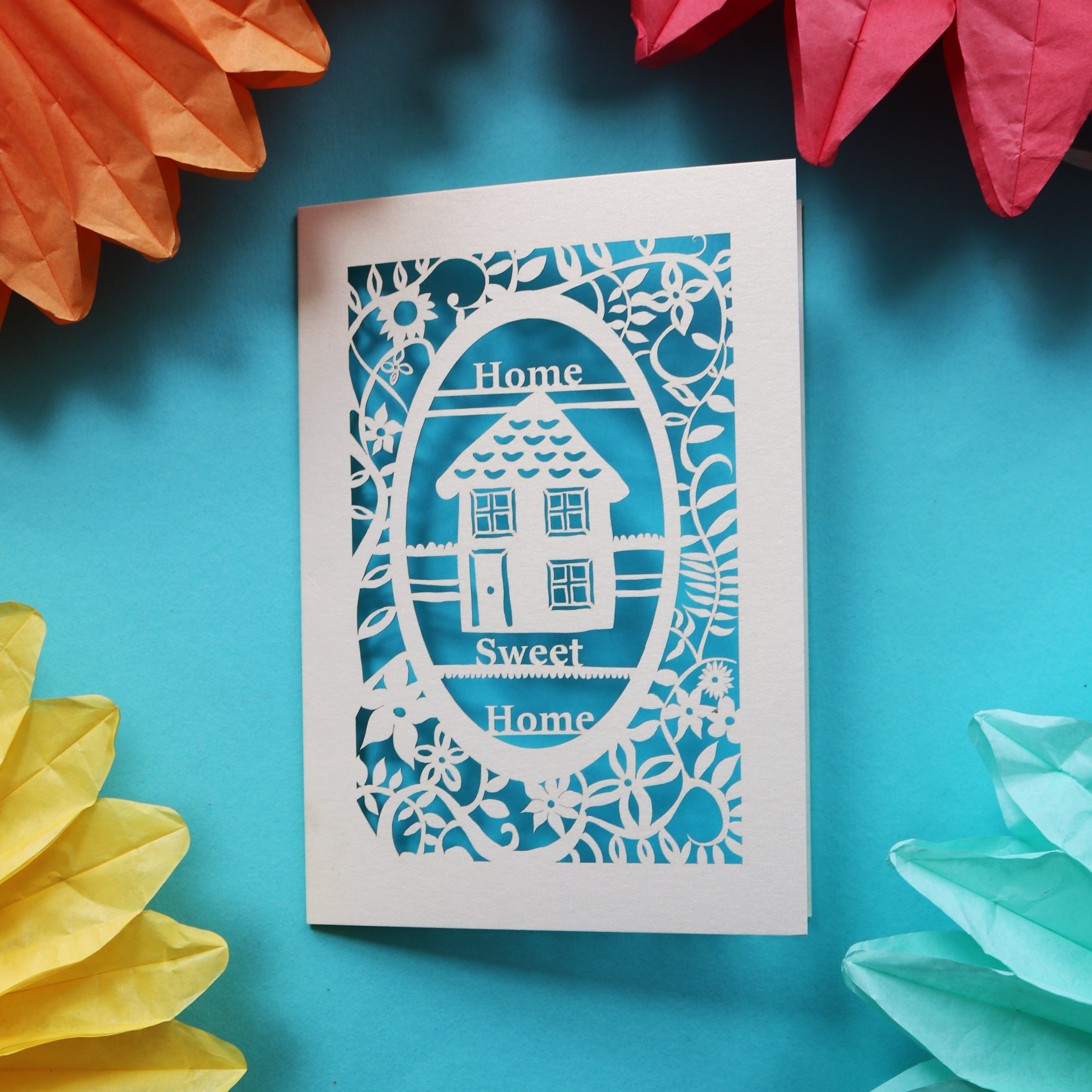 A cute new house card that has a laser cut house and the words "Home sweet home"