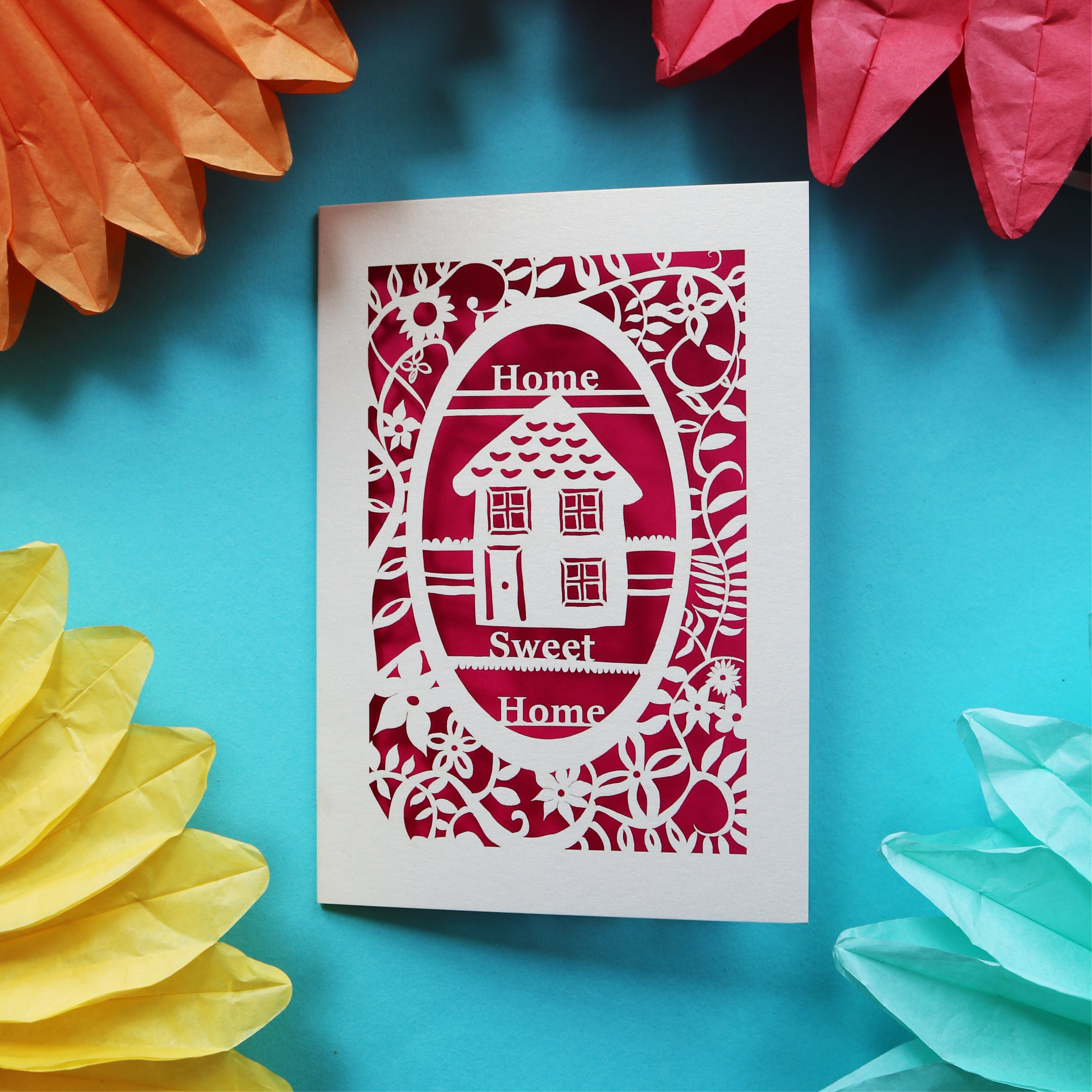 A unusual new home card that has a laser cut house and the words "Home sweet home"