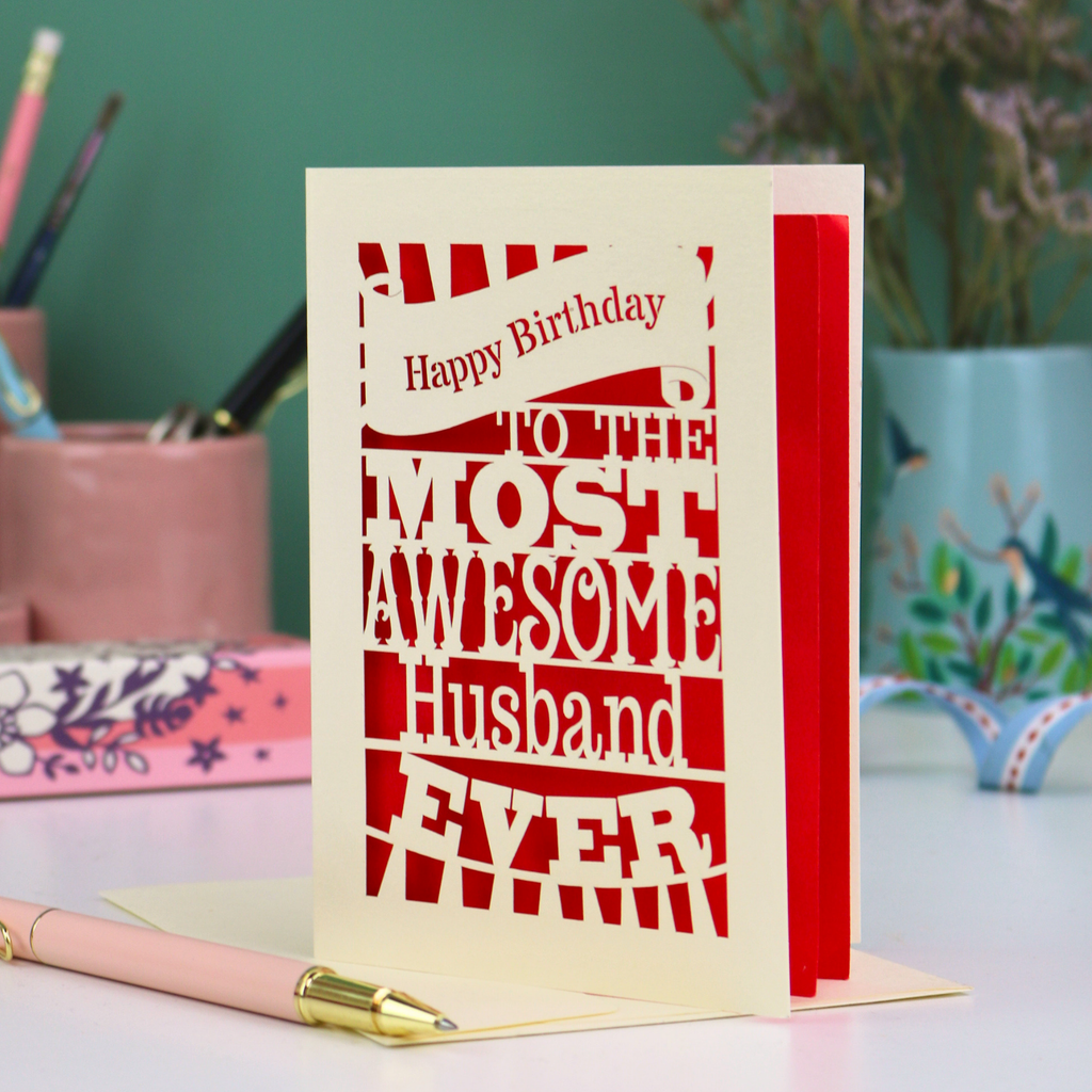 A cream paper cut Husband Birthday card with cut out text design - "Happy Birthday to the most awesome husband ever"