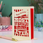 A cream paper cut Husband Birthday card with cut out text design - "Happy Birthday to the most awesome husband ever"