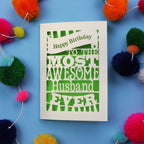 Handmade in the UK, a Husband Birthday card for the most awesome husband ever on a blue background with colourful pom-poms.