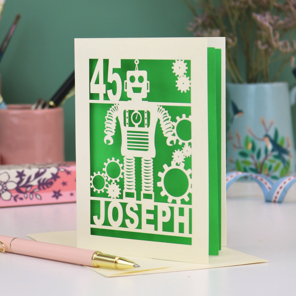 A laser cut birthday card with robot design, personalised with the age '45' and the name 'Joseph'