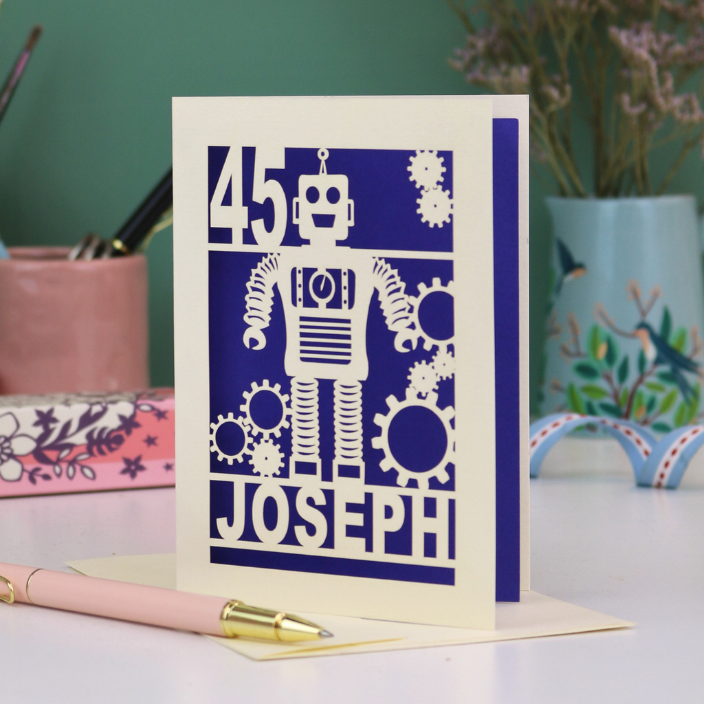 A laser cut birthday card with robot design, personalised with the age '45' and the name 'Joseph'