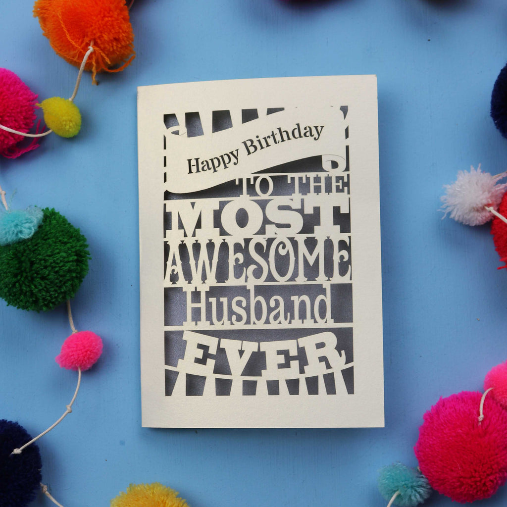 Husband Birthday cards for the most awesome husband ever on a blue background with colourful pom-poms.