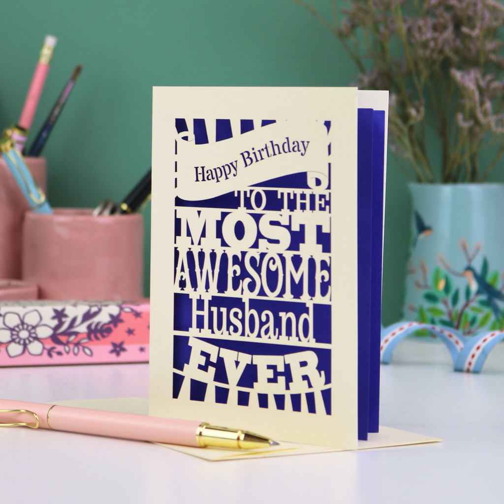 A cream and violet paper cut Husband Birthday card with cut out text design - "Happy Birthday to the most awesome husband ever"