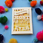 Husband Birthday card for the most awesome husband ever on a blue background with colourful pom-poms.