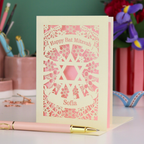 Bat Mitzvah card with decorative design and pen on a table